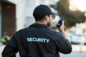 SIA licensed security guard using a radio during patrol in the UK security industry